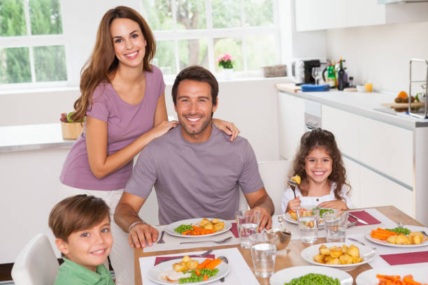 istock Family smiling at the dinner table 851675256