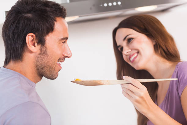 istock Man tasting dish on wooden spoon 851676608