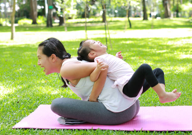 istock Mother and daughter doing exercise in the garden. 851679778