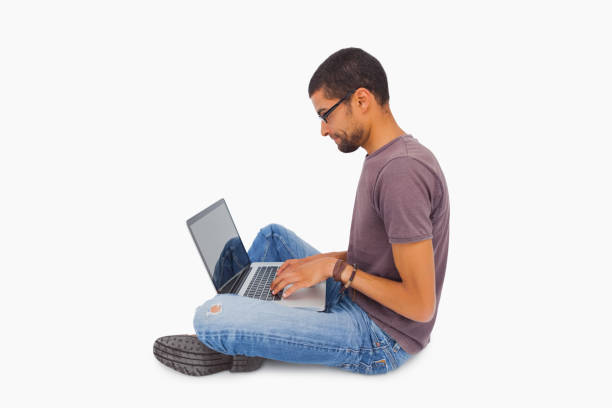 istock Man wearing glasses sitting on floor using laptop 851680134