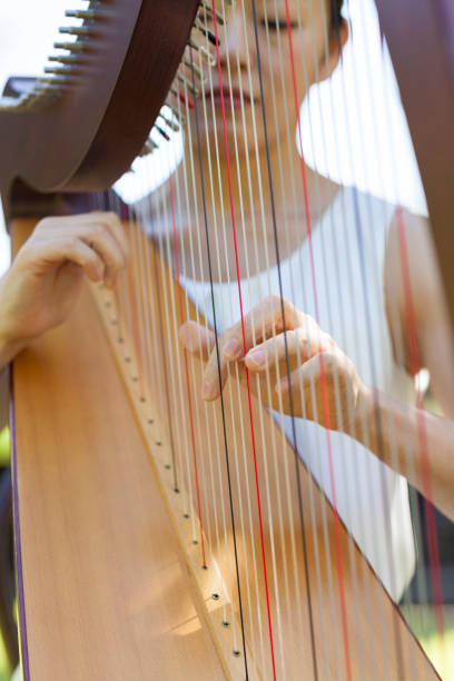 istock Woman Playing Harp Outdoors 851680190