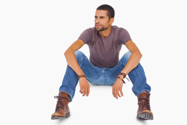 istock Handsome man sitting on floor and looking away 851680230