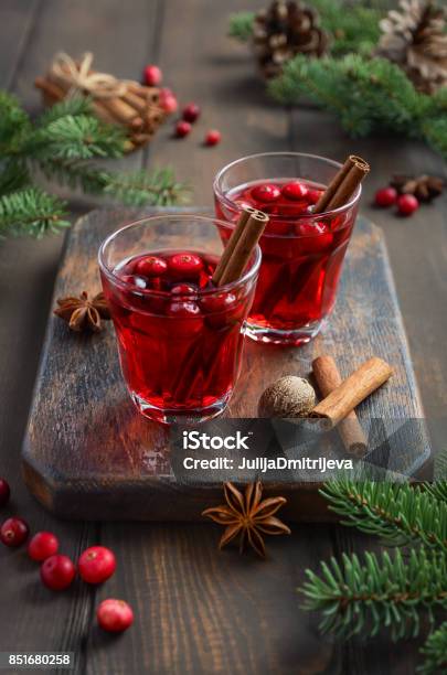 Cranberry Drink On Wooden Background Decorated With Fir Branches And Fresh Berries Stock Photo - Download Image Now