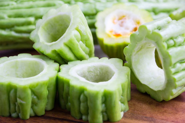 fresh green bitter cucumber or chinese bitter melon or melon sliced in pieces - lpn imagens e fotografias de stock