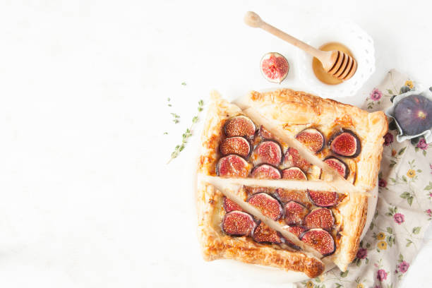 istock Fig tart with cheese, honey and thyme on white background. 851686162