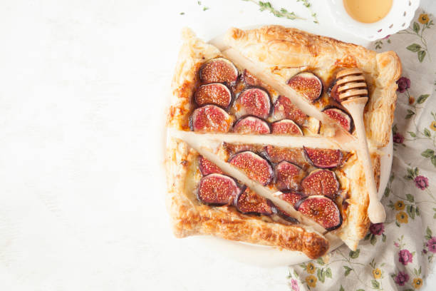 istock Fig tart with cheese, honey and thyme on white background. 851686166