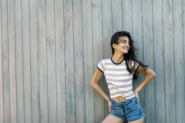 istock Young happy brunette posing at wall, outdoors shot 851689970