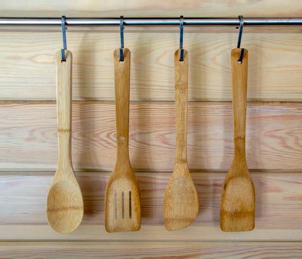 istock Wooden utensils hanging on wood kitchen wall. 851695020