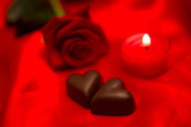 istock Red rose candle and chocolate hearts 851696038