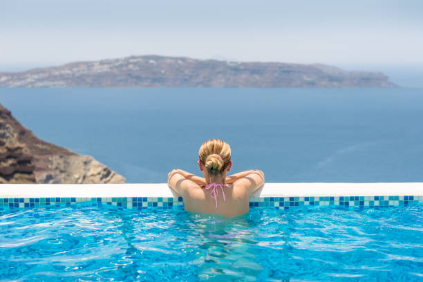 istock Woman in a infinity pool at the hotel spa 851696288