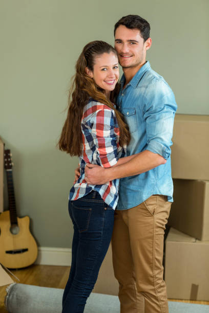 istock Romantic couple standing face to face and embracing each other 851699634