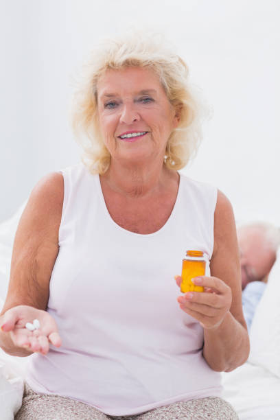 istock Calm aged woman with the opened pill bottle 851705276