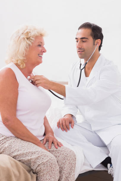 istock Doctor examining a smiling old woman 851707542