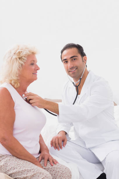 istock Cheerful doctor examining an old woman 851707586