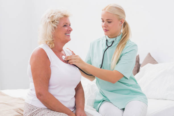 istock Home nurse examining an aged woman 851709614