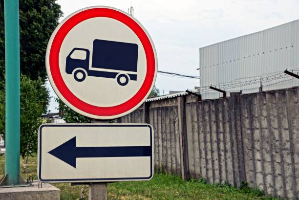 istock road signs near a gray wall with barbed wire 851717010