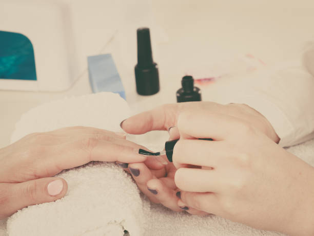 istock Woman in beauty salon getting manicure done. 851720948