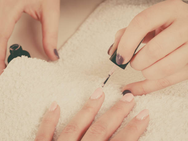 istock Woman in beauty salon getting manicure done. 851721018