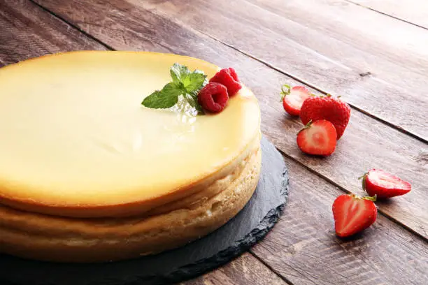 Homemade cheesecake with fresh strawberries and mint for dessert - healthy organic summer dessert pie cheesecake. Vanilla Cheese Cake.