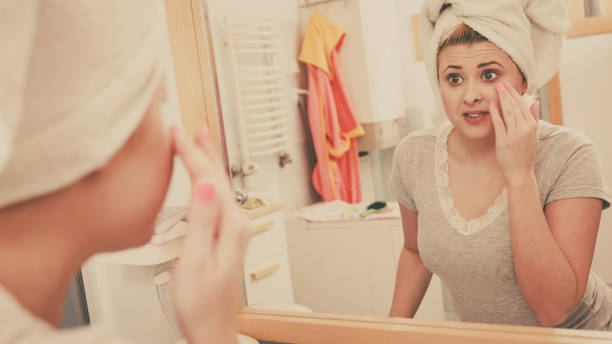 istock Woman looking at her reflection in mirror 851748462