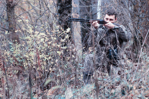 istock A man in camouflage and with a hunting rifle in a forest on a sp 851757470