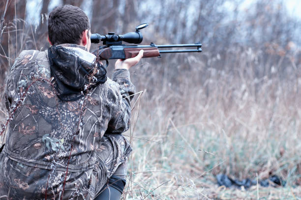 istock A man in camouflage and with a hunting rifle in a forest on a sp 851757840