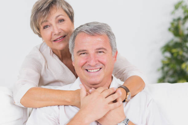 istock Old couple smiling at the camera and hugging 851758158
