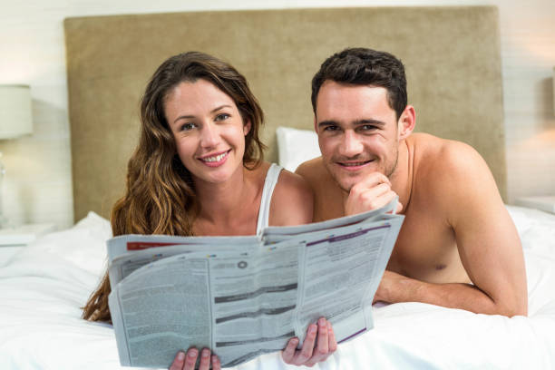 istock Smiling couple lying in bed 851762622