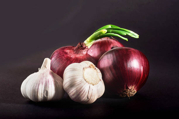 Blue purple onion and garlic isolated white on a black background Blue purple onion and garlic isolated white on a black background. entire track stock pictures, royalty-free photos & images