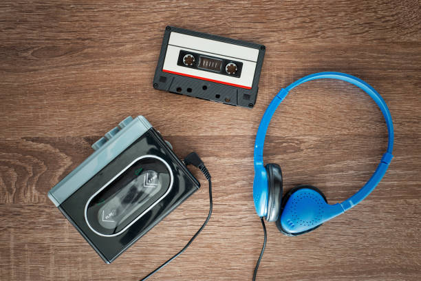 Vintage walkman, cassete and headphones. Vintage walkman, cassete and headphones on the wooden background walkman cassette stock pictures, royalty-free photos & images