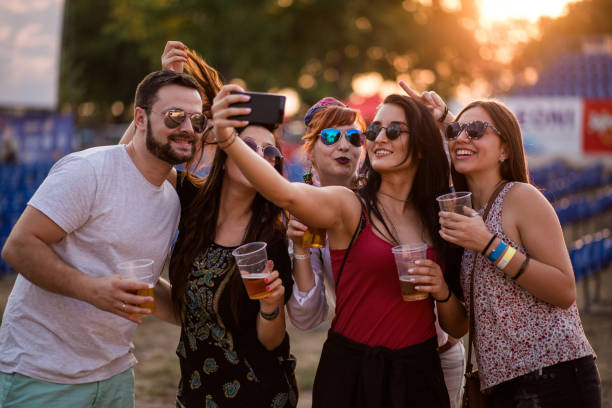 Cheerful People Making Selfie Cheerful People Making Selfie At Music Festival beer festival photos stock pictures, royalty-free photos & images