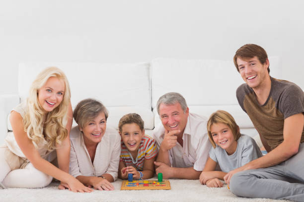 istock Family looking at the camera with board games 851771132