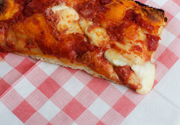 Slice of Pizza on Paper Napkin in Italy
