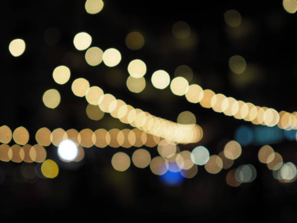 istock Curve multiple row yellow bokeh, black background 851779646