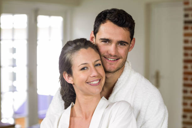 istock Couple in bathrobe embracing each other 851780756