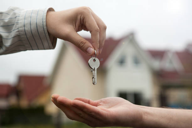 istock hand of a man handing keys to a man's hand 851789092