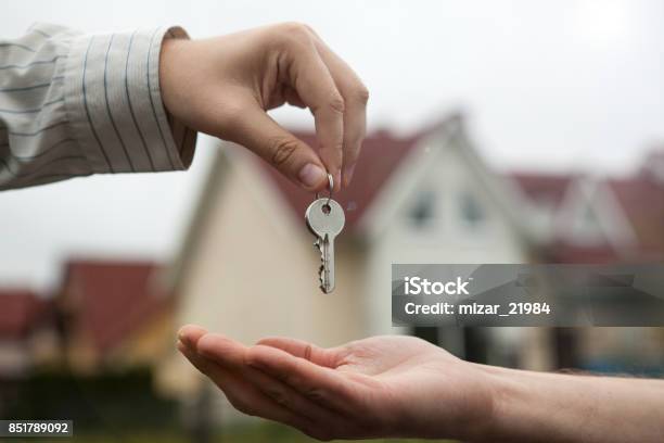 Hand Of A Man Handing Keys To A Mans Hand Stock Photo - Download Image Now - Apartment, Built Structure, Business