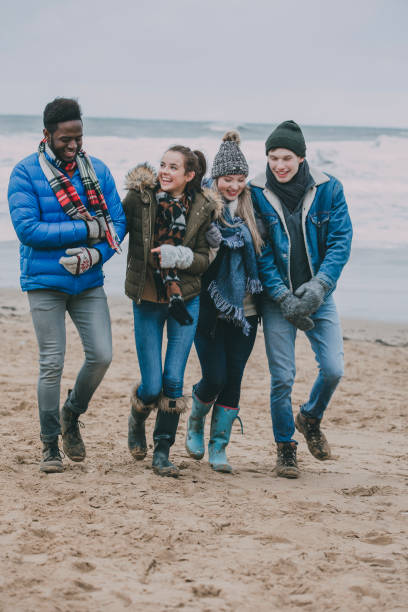 istock Friends Walking Along A Winter Beach 851789098