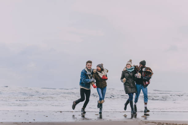 istock Friends Having Fun On A Winter Beach 851789102