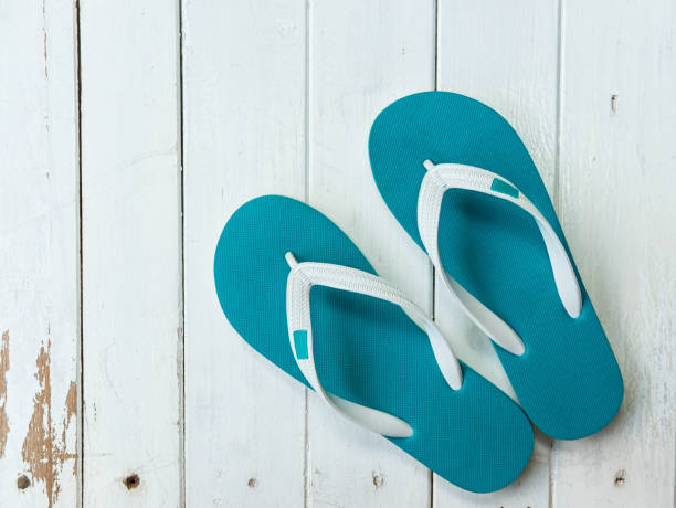 istock Green blue color toe post rubber sandal on white wooden background 851789894
