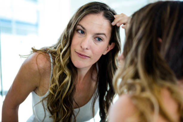 istock smiling woman fixing her hair 851790284