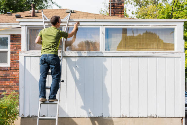 istock Man painting white trim on ladder 851790812
