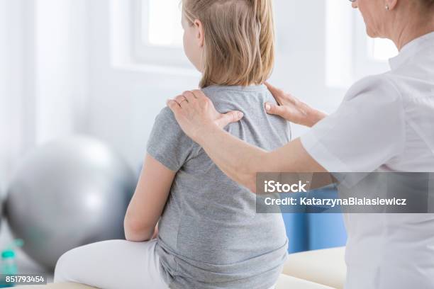 Physiotherapist Doing Massage To Girl Stock Photo - Download Image Now - Child, Physical Therapy, Scoliosis