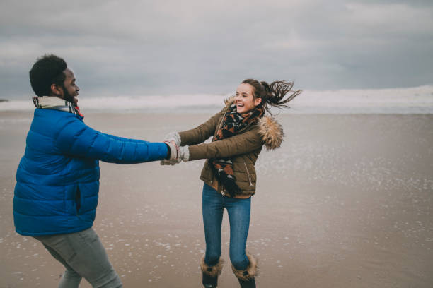 istock Young Couple Dance On A Winter Beach 851794872
