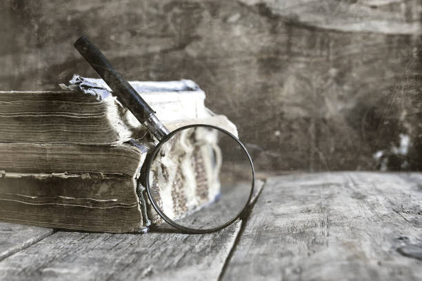 istock old scratched effect on photo magnifying glass and old book 851794956