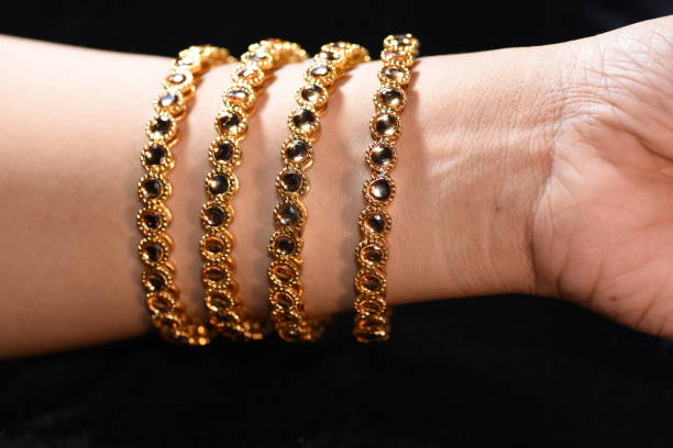 istock Fancy gold looking imitation bangles / bracelets on the woman's wrist 851800456