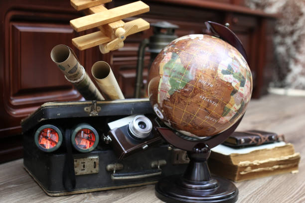 istock composition on a wooden floor vintage globe with old leather sui 851802764