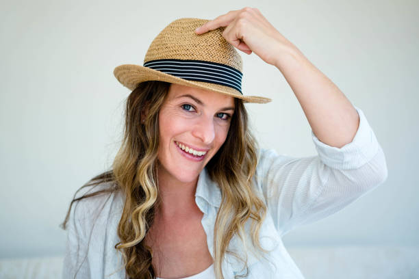 istock woman wearing a straw fedora smiling into the camera 851805130