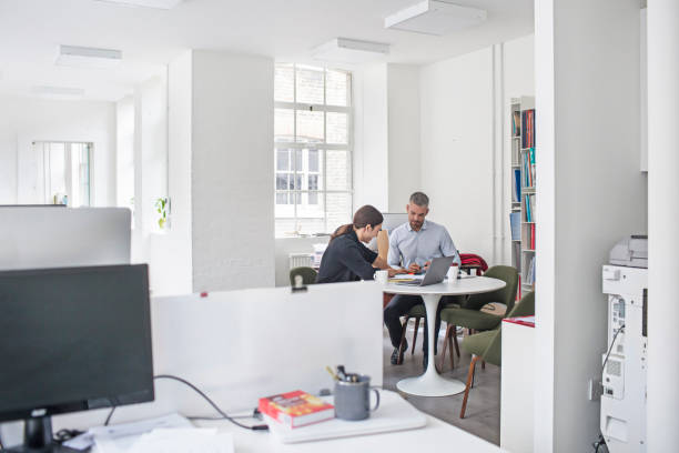 istock Male professionals working with laptop at office 851809692