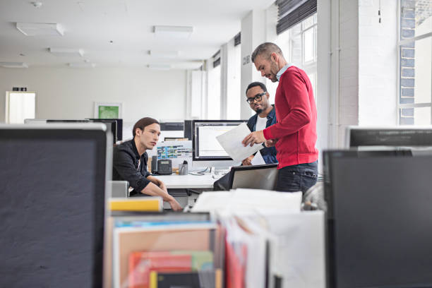 istock Businessman showing document to young colleagues 851809706